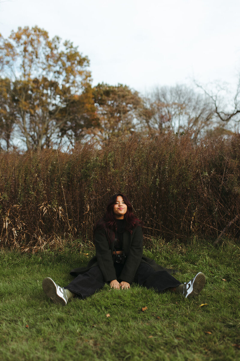 girl smiling sitting on grass