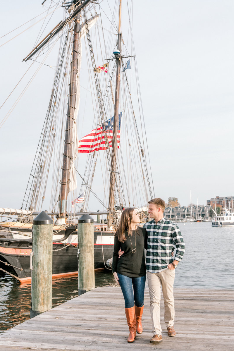 couple walks pier in Annapolis for best engagement photos