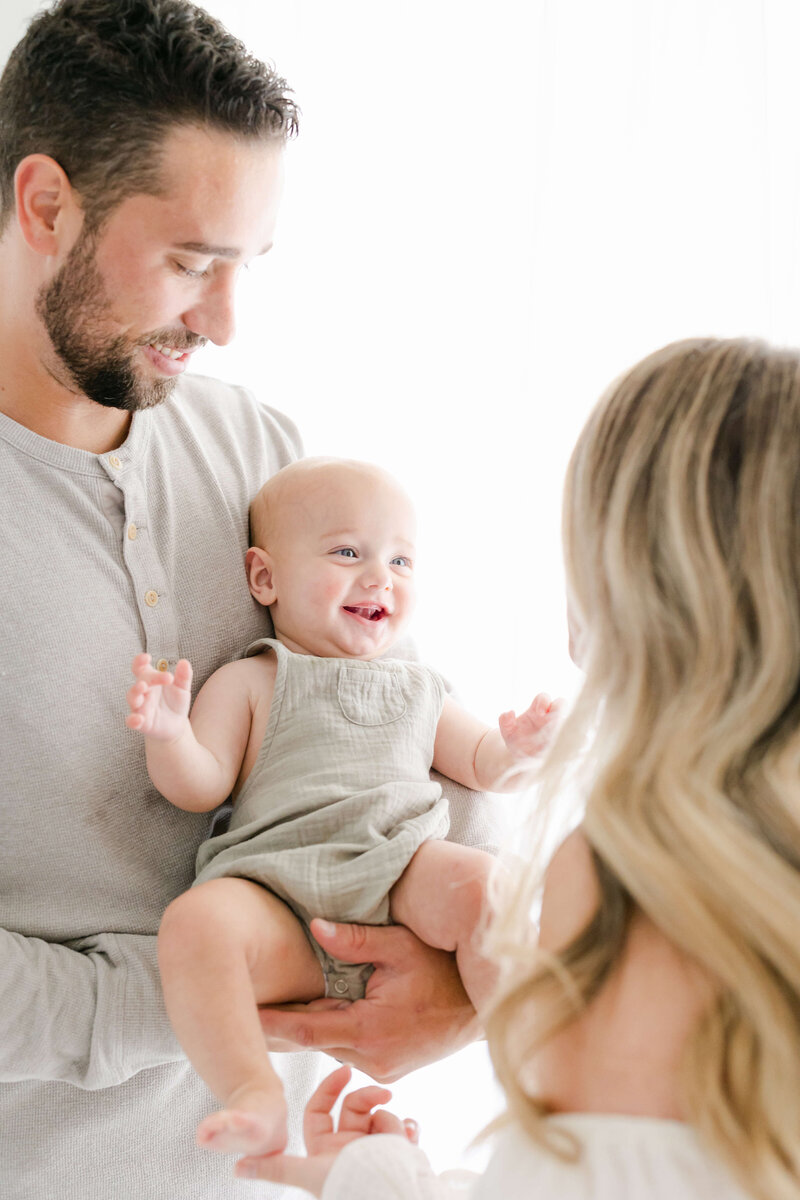 a baby smiling at her mom
