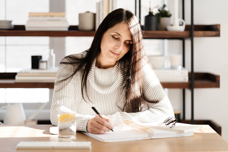 women sitting at her desk