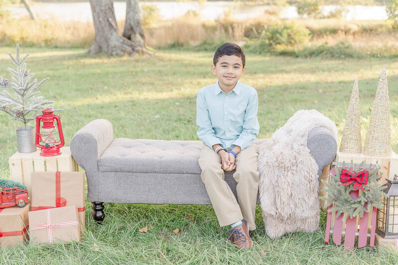boy sitting on a couch taken by a Fairfax County, Virginia Christmas minis photographer