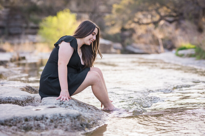 girl sitting looking at the water