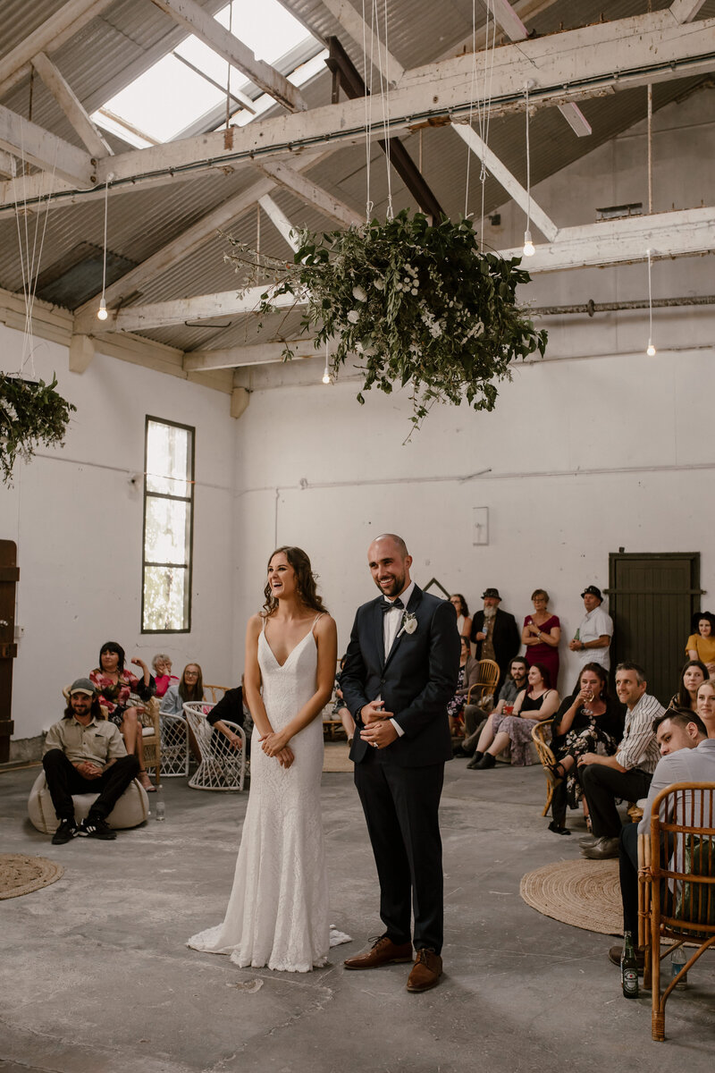 Alkina and Jaron standing in their wedding reception room and photographed by taranaki wedding photographer aimee kelly photography