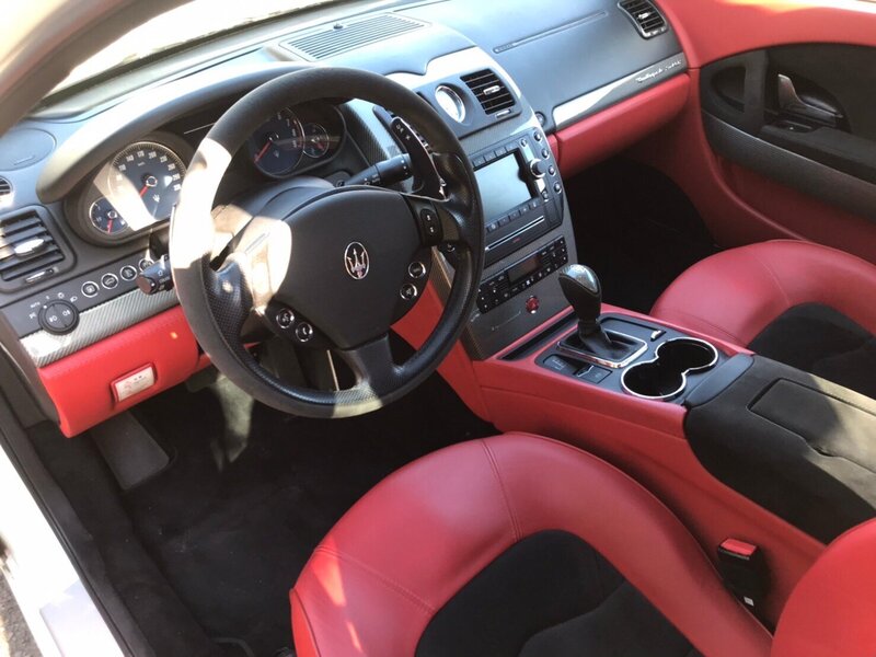 A close-up view of the Maserati Quattroporte GTS luxurious red leather interior and sleek dashboard, offering a glimpse into the high-end comfort of Tokyo Luxe Drive’s premium car collection.