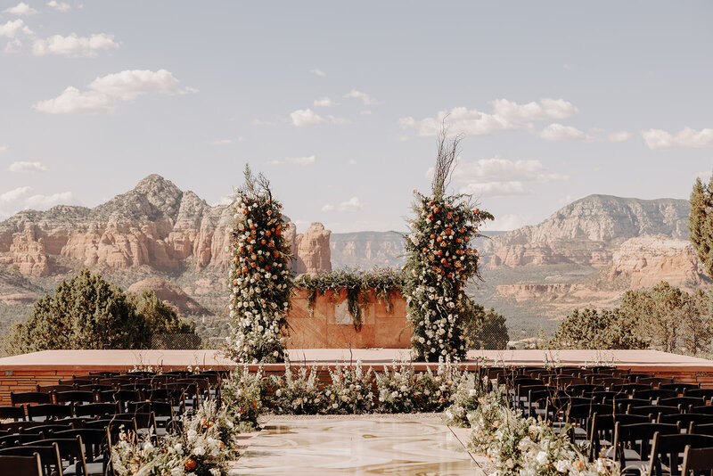 Wedding ceremony setup with floral décor and panoramic desert views in Arizona