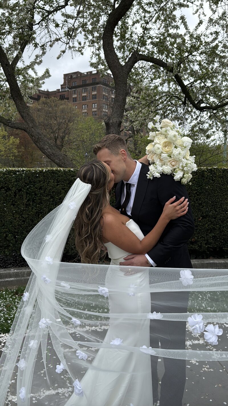 real life moment of couple kissing at their wedding venue outdoors in cleveland, ohio