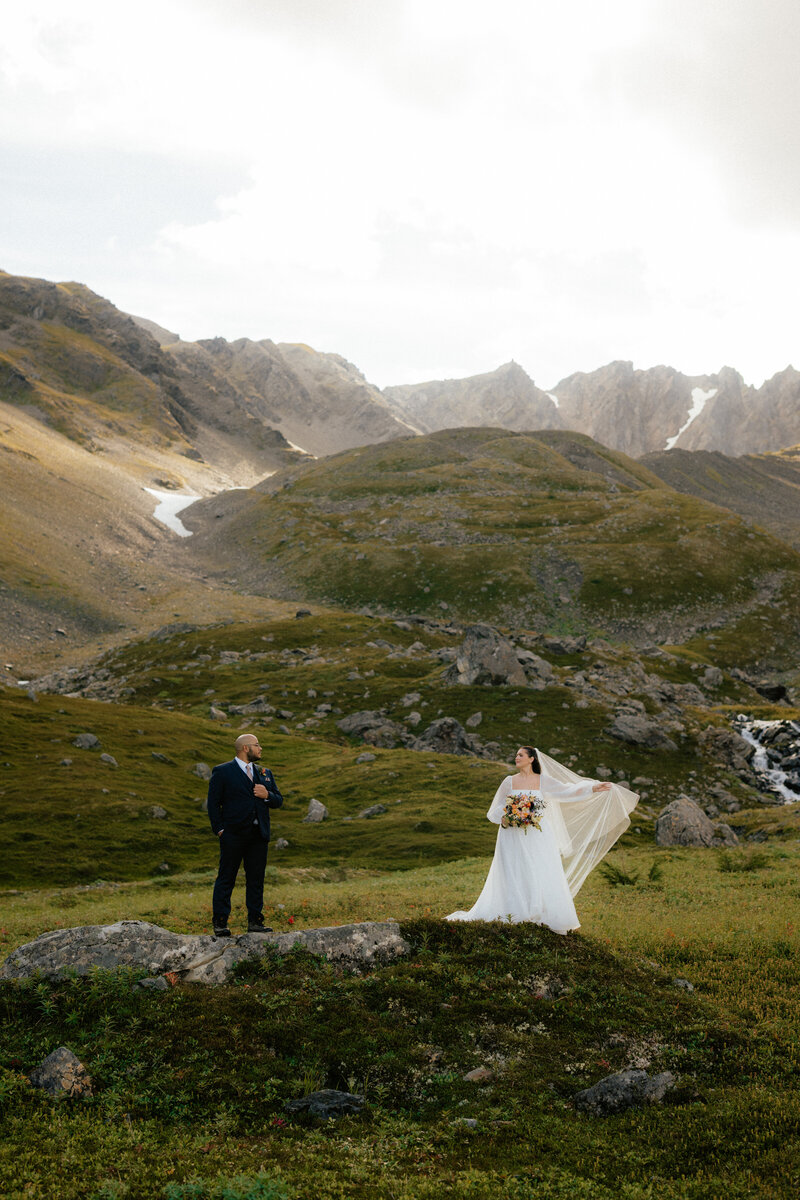 Bride and groom celebrating their Seward Alaska elopement on Mount Marathon.