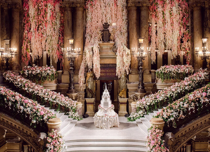 Double staircase decorated with pink and white flowers