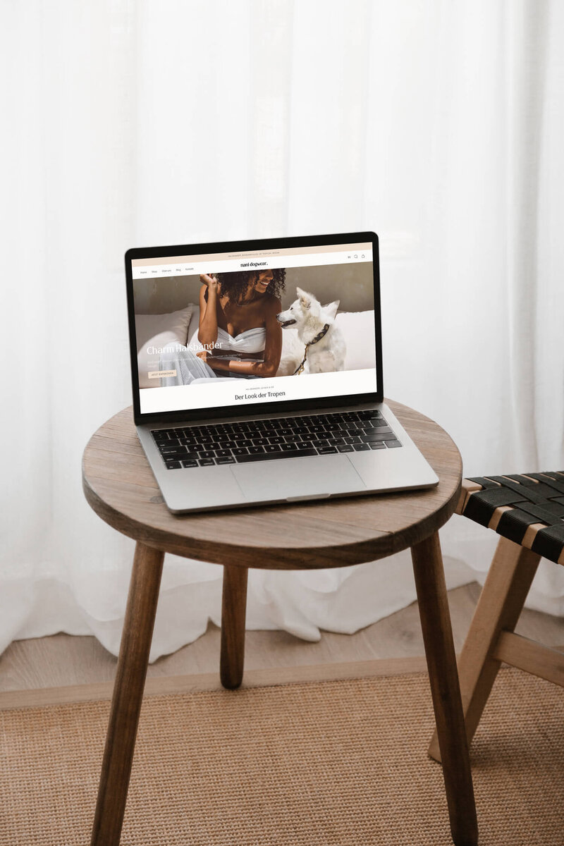Laptop mockup showing an elegant, feminine yet minimal shopify online shop for a tropical dogwear brand