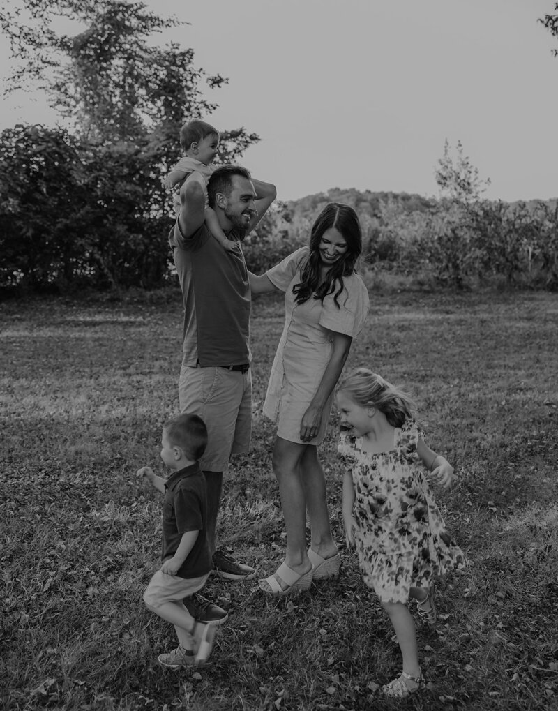 black and white family photo taken outdoors in ohio with family playing