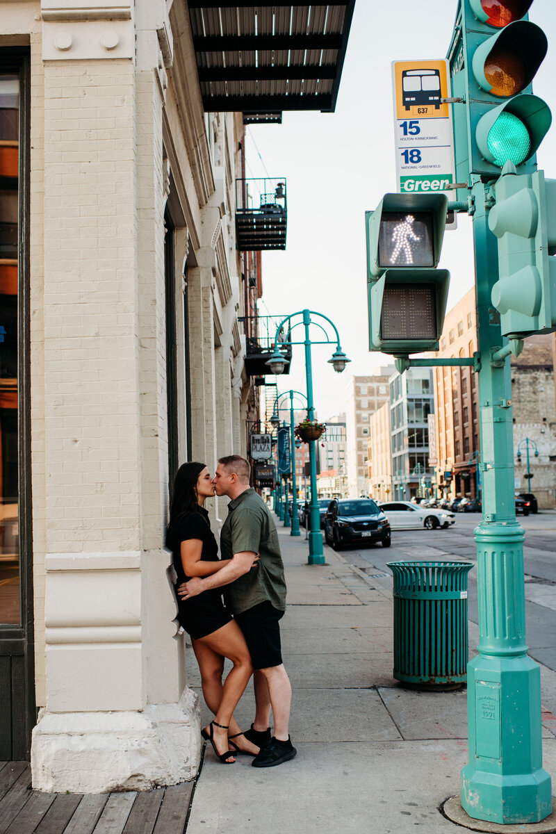 Man kissing woman on the street in downtown Milwaukee