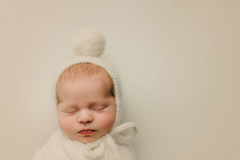 sleeping newborn baby with white wrap