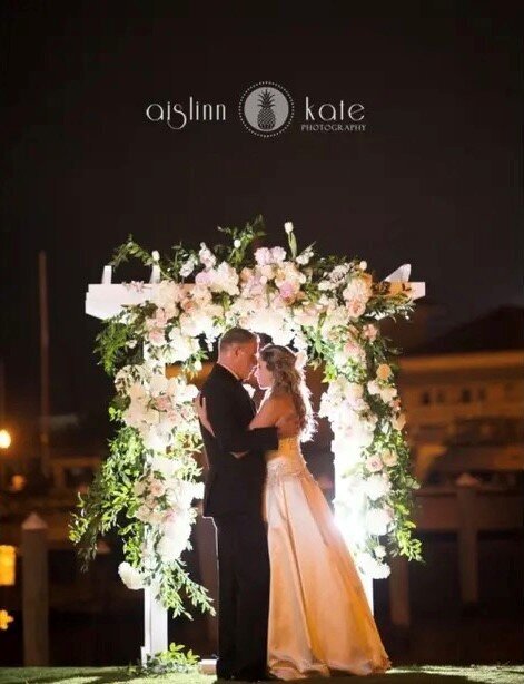 Beautiful Florals on White Arbor on the Green at  the Venue Palafox Wharf Waterfront Pensacola, FL  Best Wedding Venue on Palafox