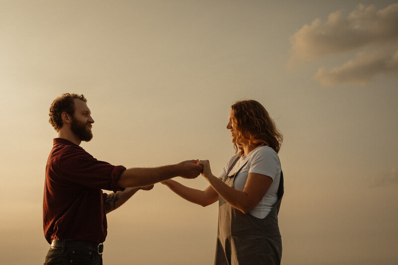 Couple holding hands at sunset at Patricia Beach 