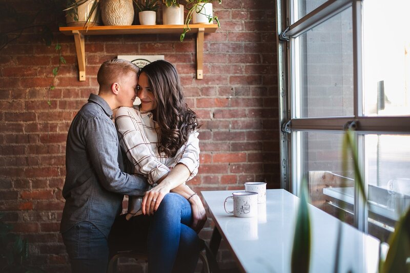 couple-embracing-in-cozy-coffee-shop-setting-captured-during-warm-and-intimate-franklin-indiana-couples-photography-session