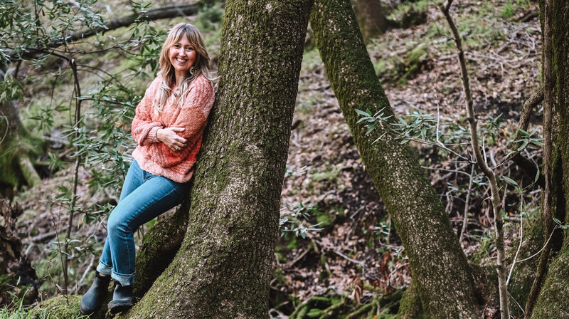 Sefora-coach-leaning-against-tree