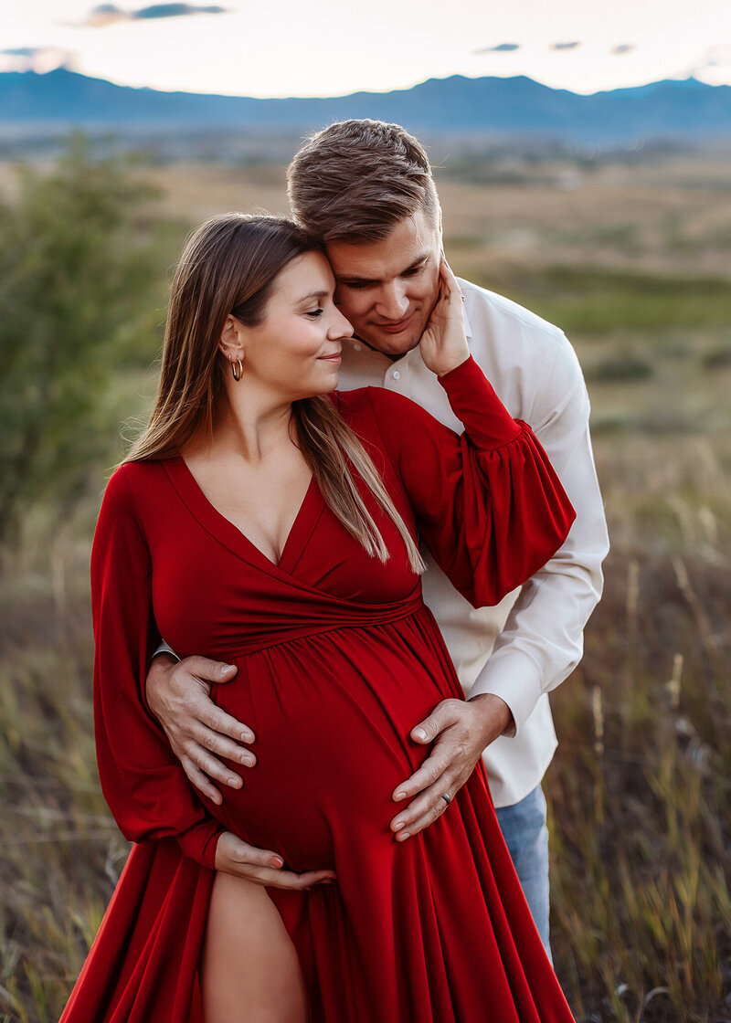 denver couple embracing for their photos befoe baby arrives