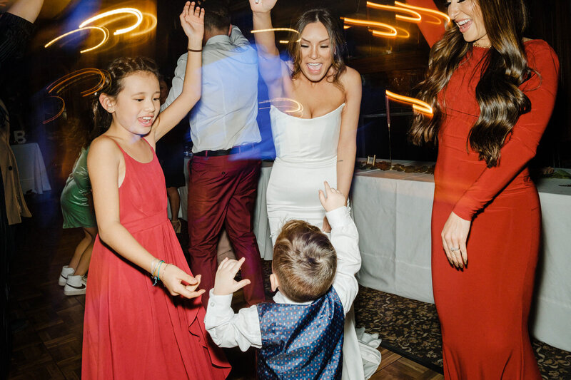 Bride dancing with a young wedding guest