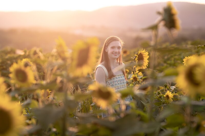Senior-girl-smiling-in-sunflowers
