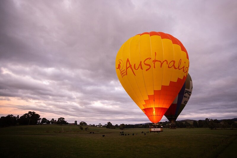 A large orange hot air balloon that says Australia on the side.