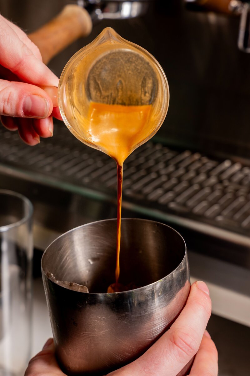 Close-up of espresso being poured at Grain Artisan Bakery using Velton’s Coffee — highlighting local partnerships and handcrafted beverages.