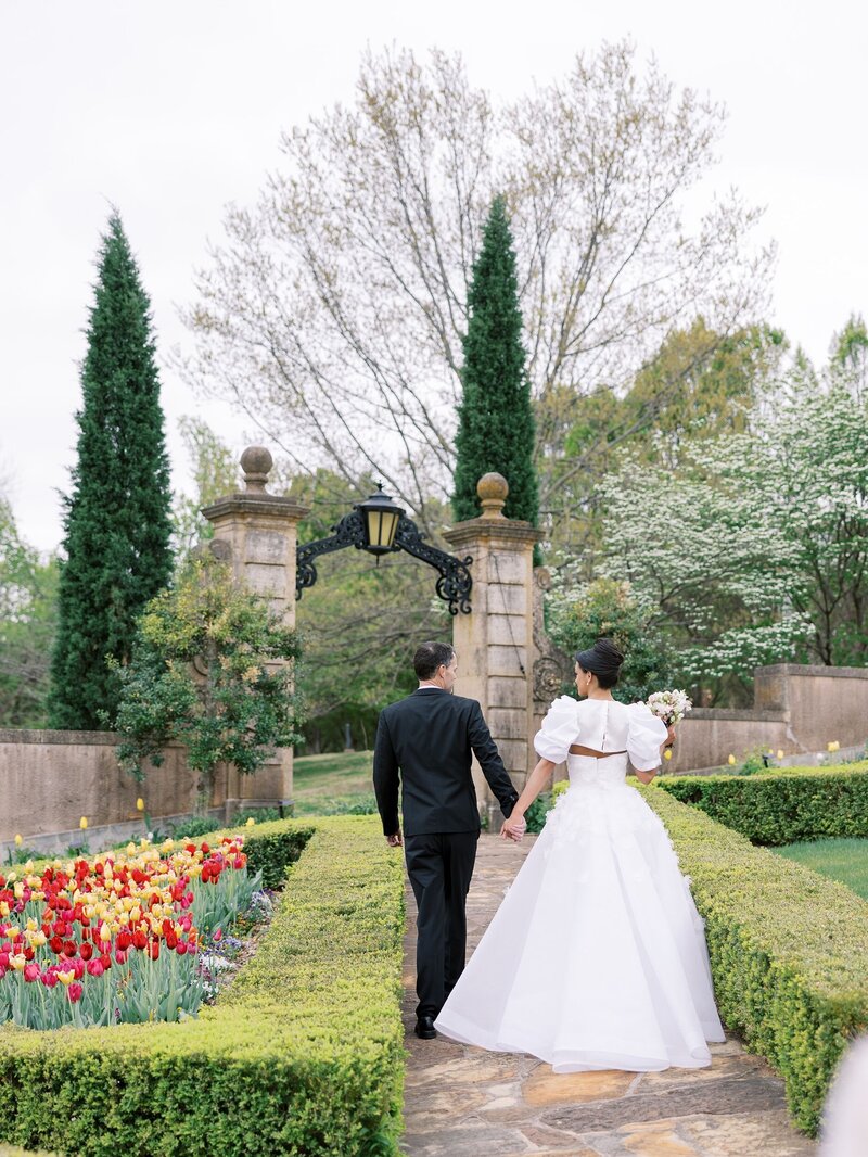 Bride and groom walking in the gardens at the Philbrook