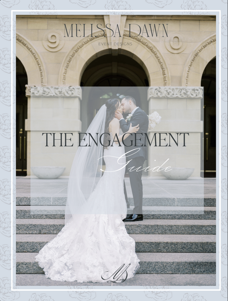 A couple embraces and kisses on the steps of a grand building, with "Melissa Dawn Event Designs" and "The Engagement Guide" text overlayed on the image. The bride wears a long, flowing white gown, symbolizing the elegance brought by full-service wedding planning.