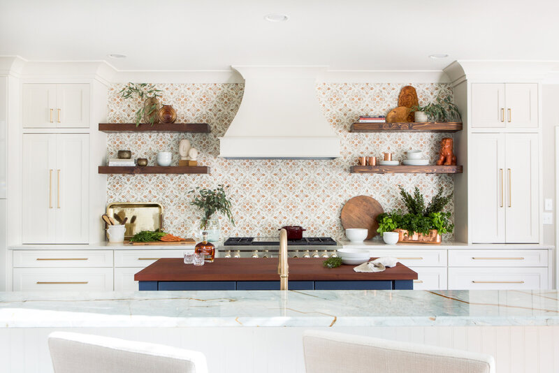 Vibrant kitchen in Lake Norman, NC, with open shelving, patterned backsplash, and warm accents.