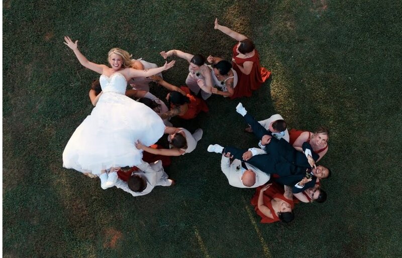 Wedding parties holding up newlyweds 