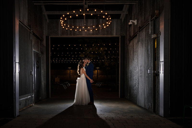 Bride and groom at night at outdoor and indoor wedding venue WareHouse 109 in Plainfield, IL