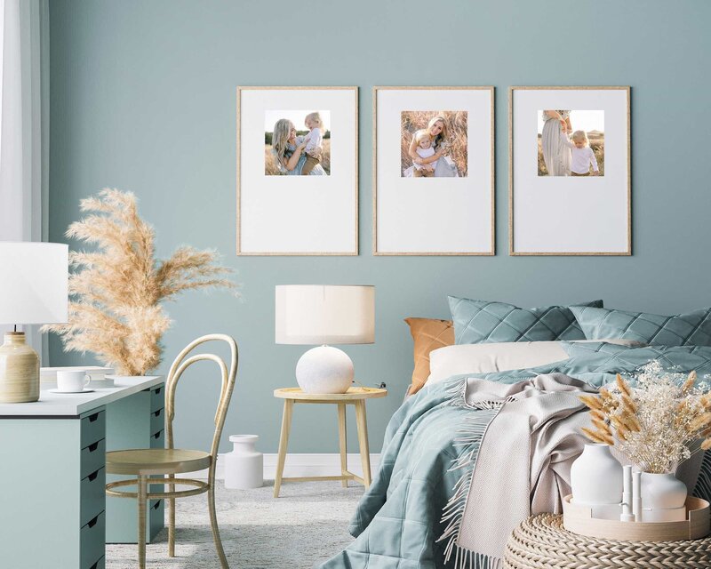 Bedroom with framed family photographs on wall
