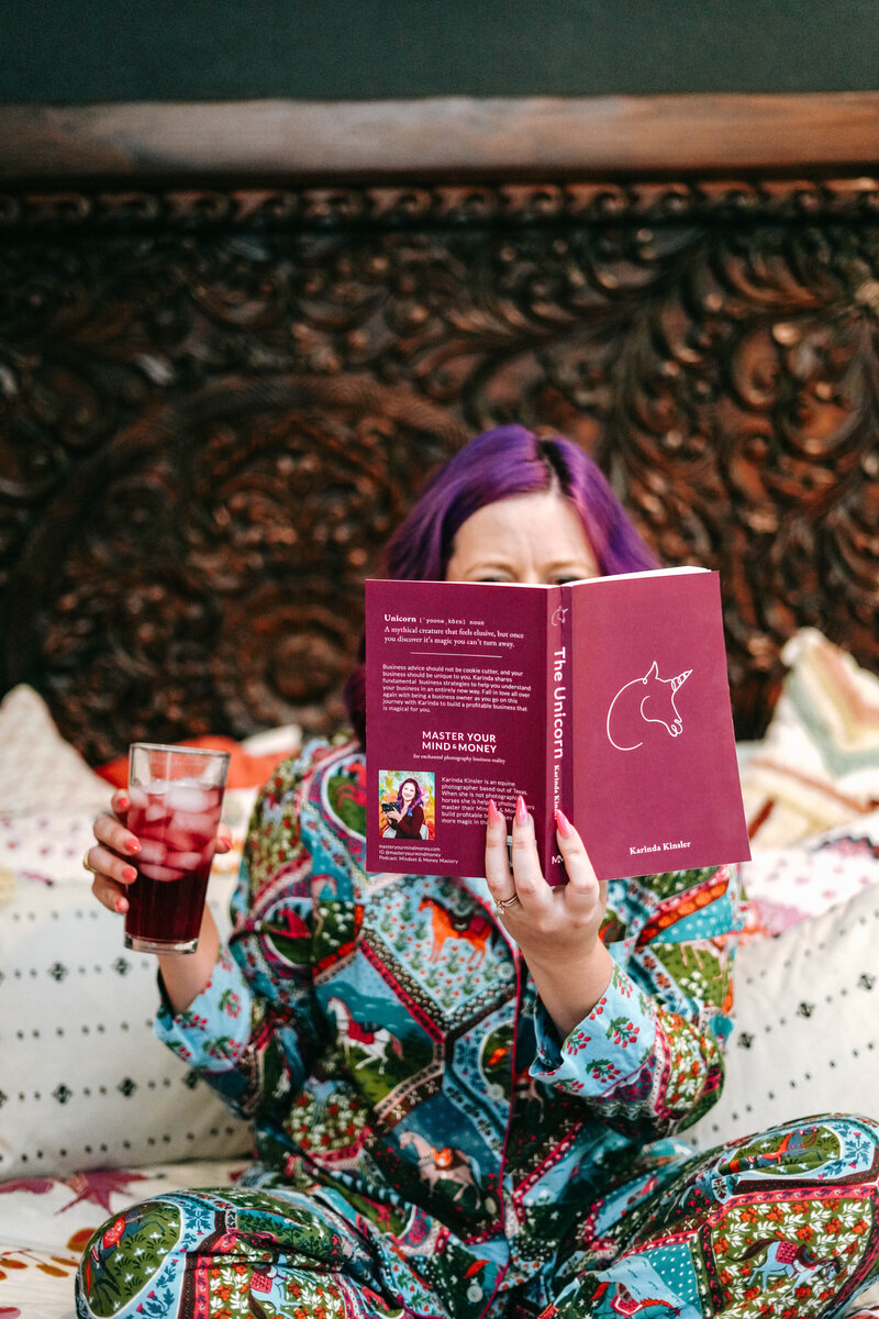 The Unicorn Book | Photography Business Guide for Real Growth | Karinda reading the Unicorn Photography Business Coach