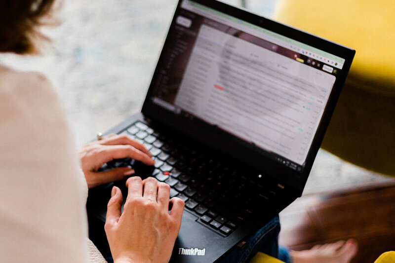 Andrea Shah, a copywriter working on her laptop