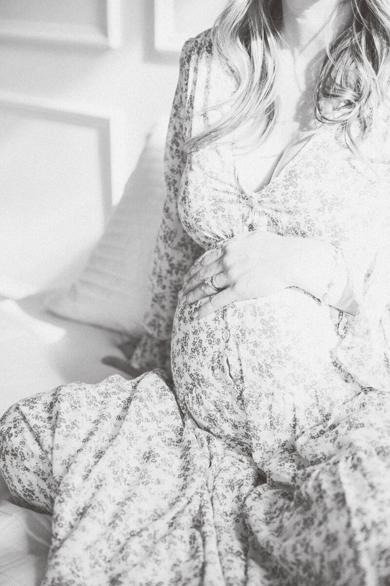Black and white close-up of newborn swaddled in floral wrap during a Charlotte NC newborn session