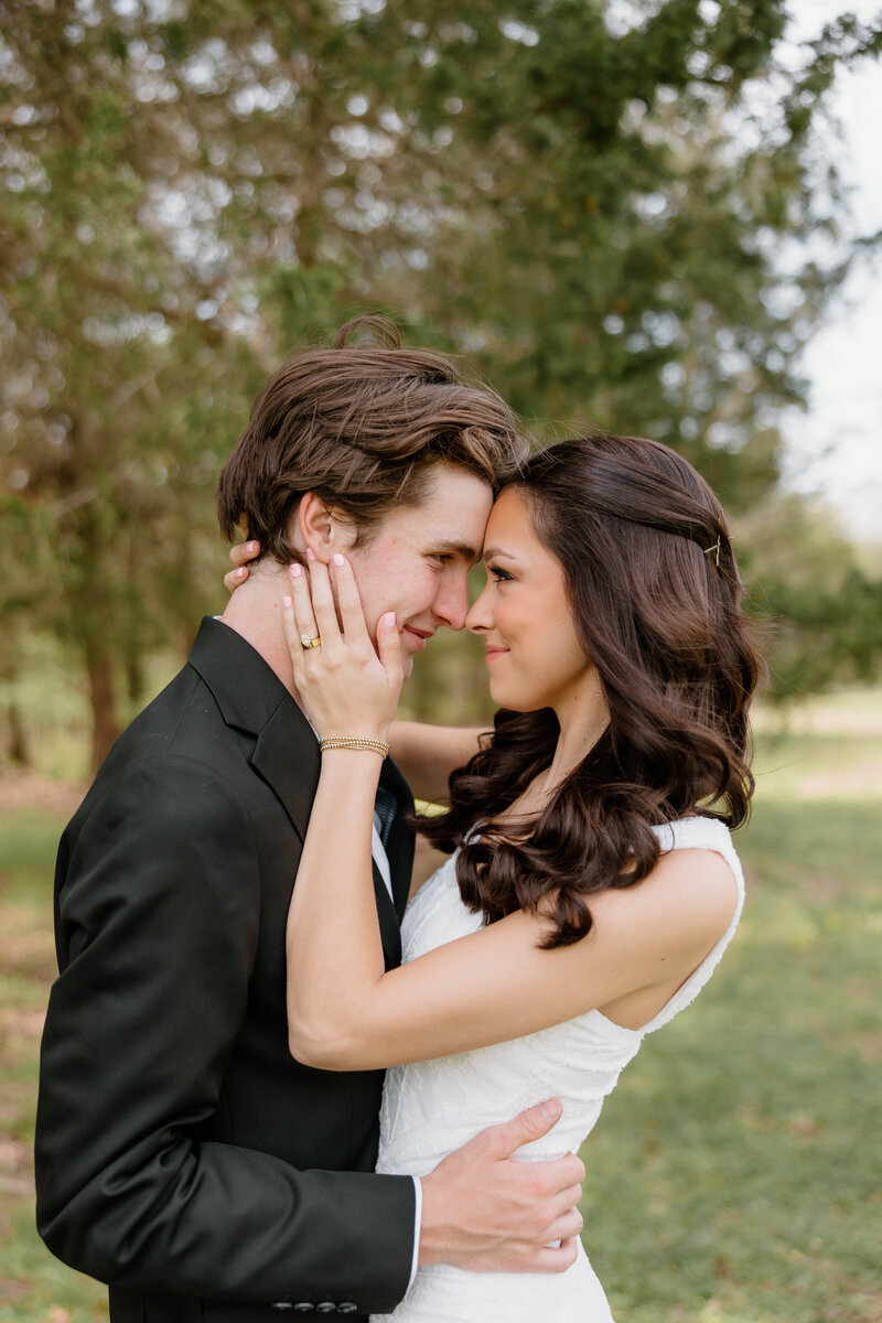 bridal portraits of bride and groom holding each other and smiling