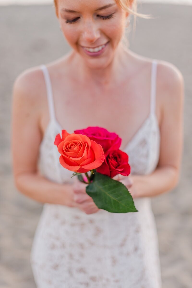 Woman's hands holding three colorful roses