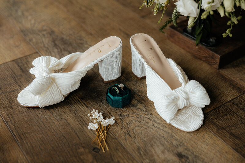 The bridal shoes with the wedding rings.