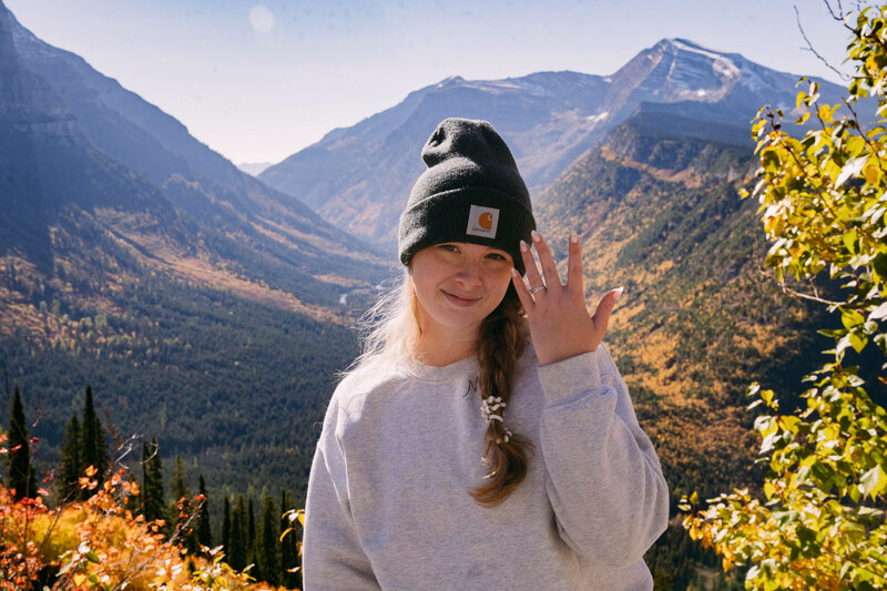 Chloe shows off her ring in a gorgeous mountain landscape.