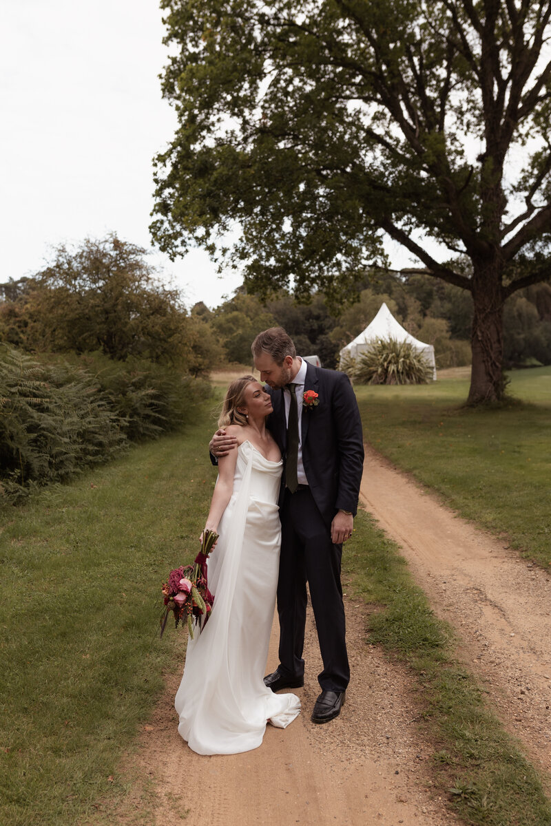 Wedding photographer captures couple taking a stroll hand in hand at their french chateau wedding.