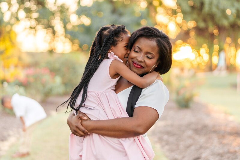 mother and daughter in a rose garden