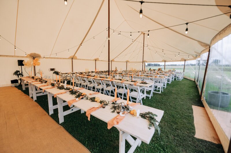 wedding reception setup with yellow and orange citrus theme at farm chapel at waimumu near gore