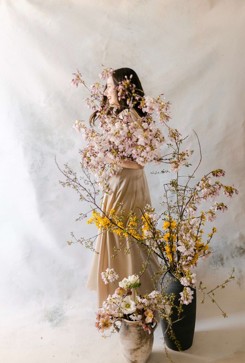 woman holding flowers and smiling
