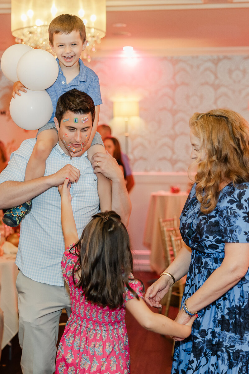 Candid photo of playful family at a party.