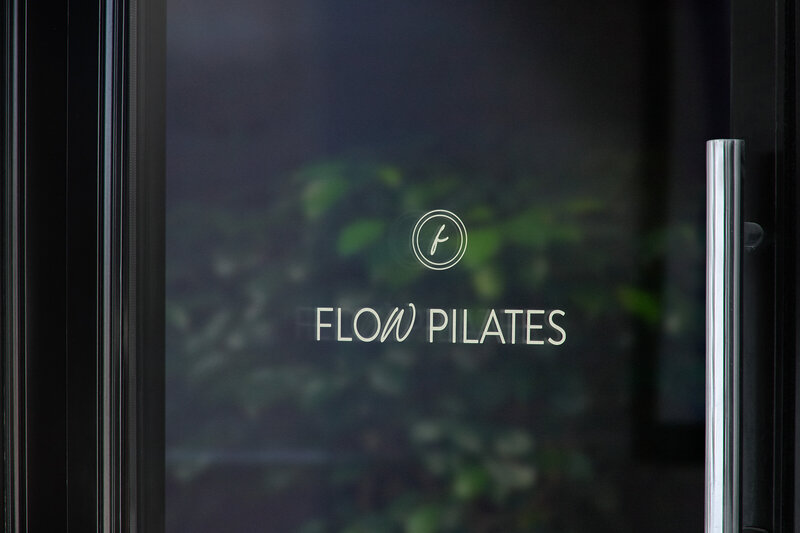 Flow Pilates logo for doorway of location based business