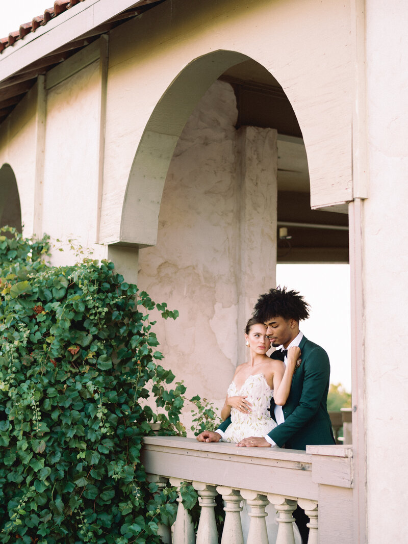 Editorial bride and groom looking at the sunset on their wedding day