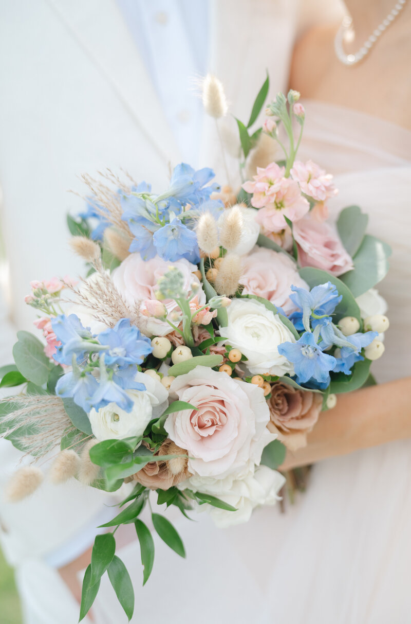 A blue white and pink bridal bouquet of fresh flowers 