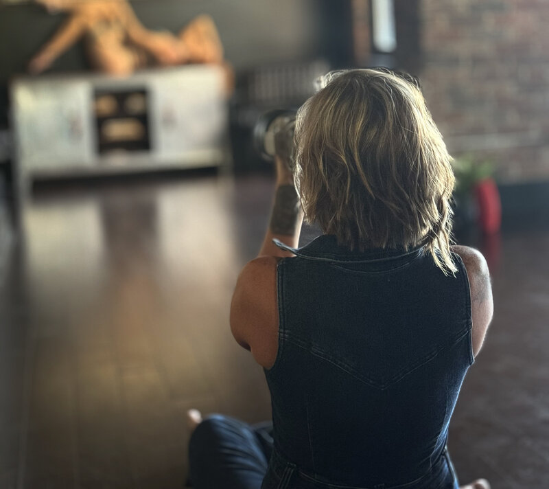 Behind-the-scenes moment of Christie helping a client prep for her session