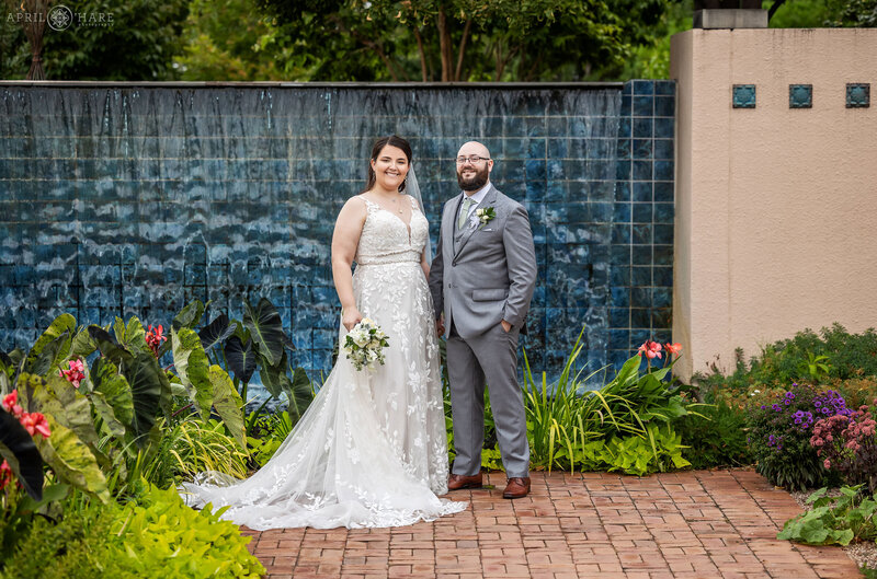 Cute wedding photo of a couple in front of the blue tile water fountain at Dener Botanic Gardens