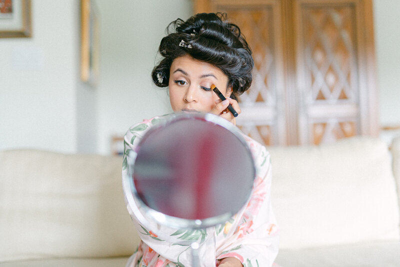 A pretty bride puts on make-up for her big day.