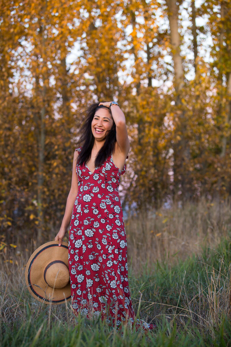indigenous model laughing  standing in tall grass